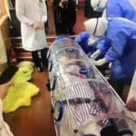 coronavirus-patient-is-sealed-in-a-plastic-tube-to-avoid-contaminating-others-as-medics-in-hazmat-suits-transport-him