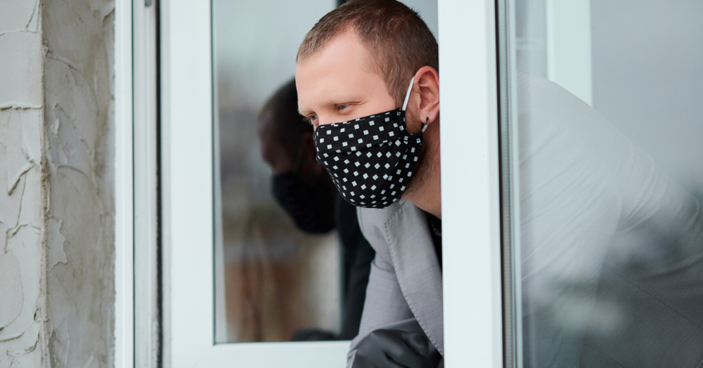 Man standing at window on coronavirus lockdown