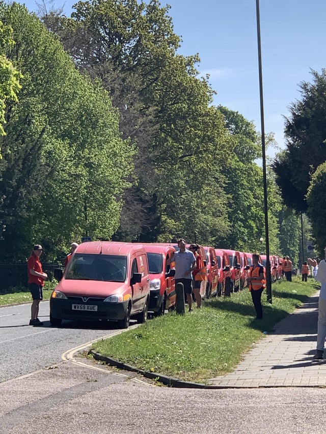 Post vans lined along street 