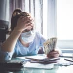 Coronavirus trigger dropping the economy in the world. Girl at home considers the budget. Virus, undermining the economy
