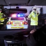 male-and-female-police-officers-pulling-over-driver