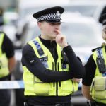 Police stand behind a cordon in Birstall near Leeds