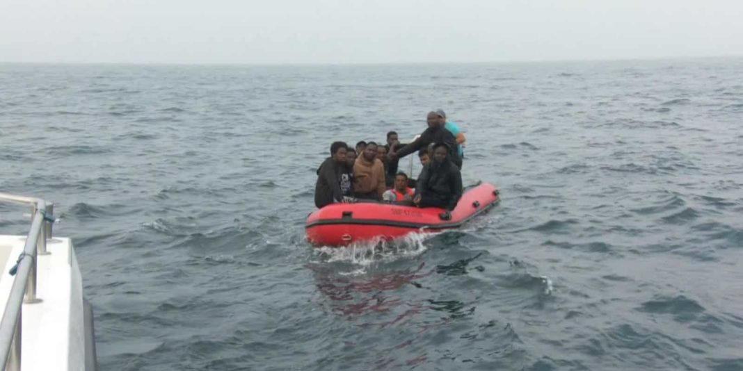 Migrants cheer 'UK' as several boats cross English Channel in one morning