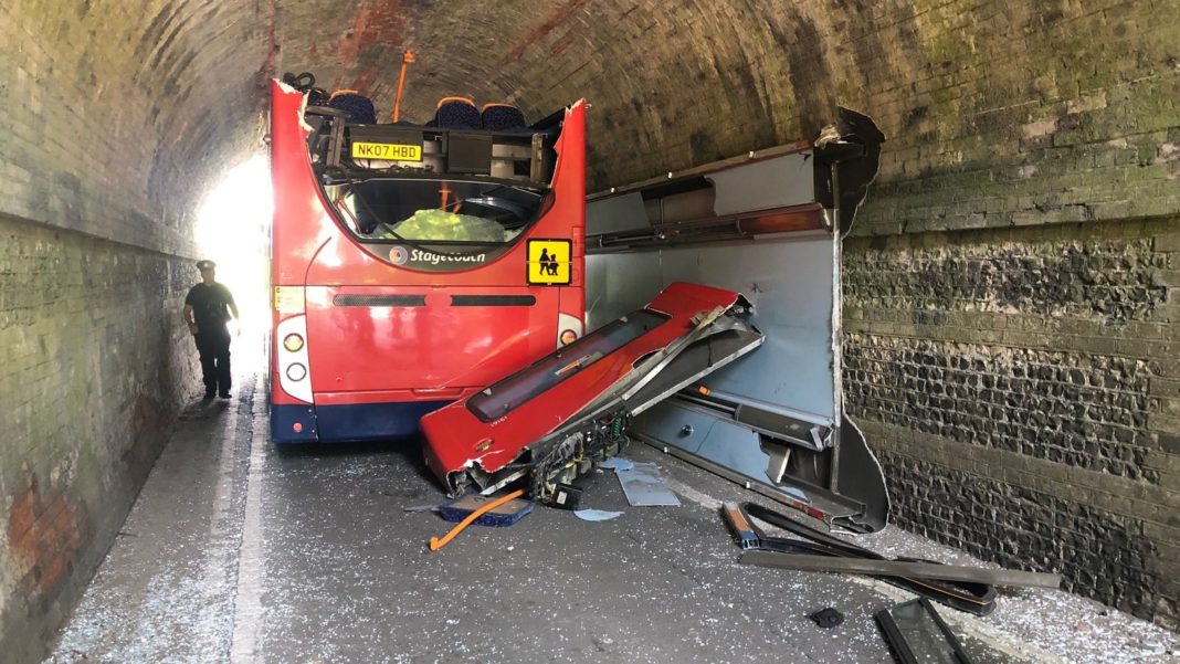 roof torn off after hitting bridge, leaving children 'seriously' injured