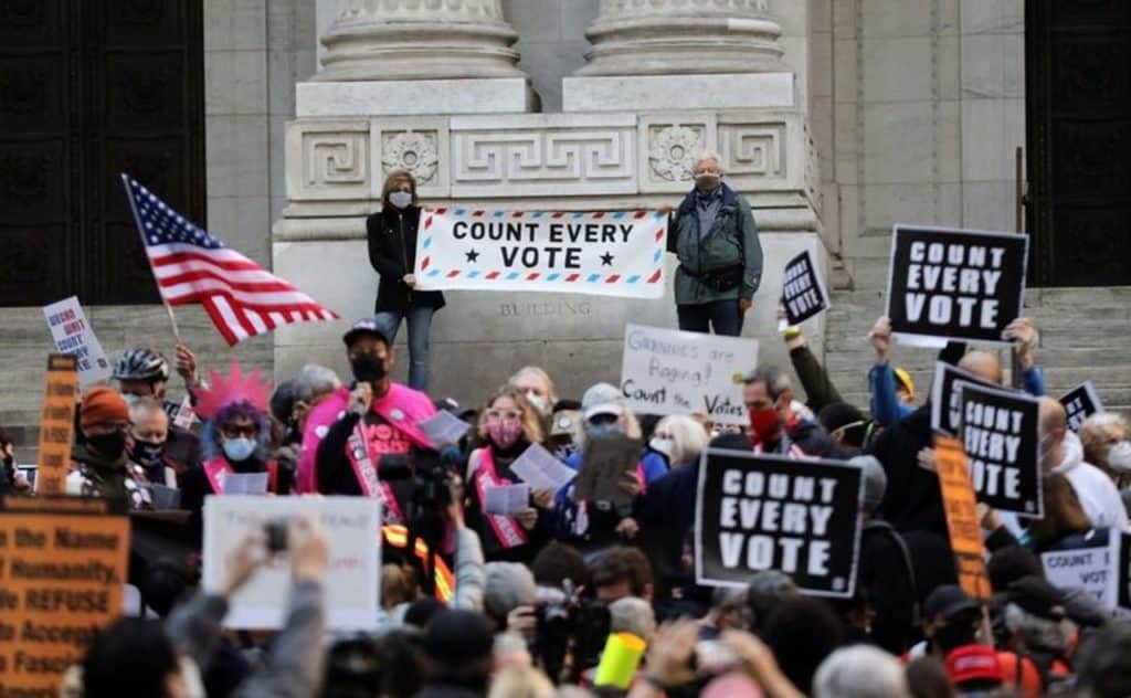 Trump supporters, some armed with rifles, outside vote counting centres