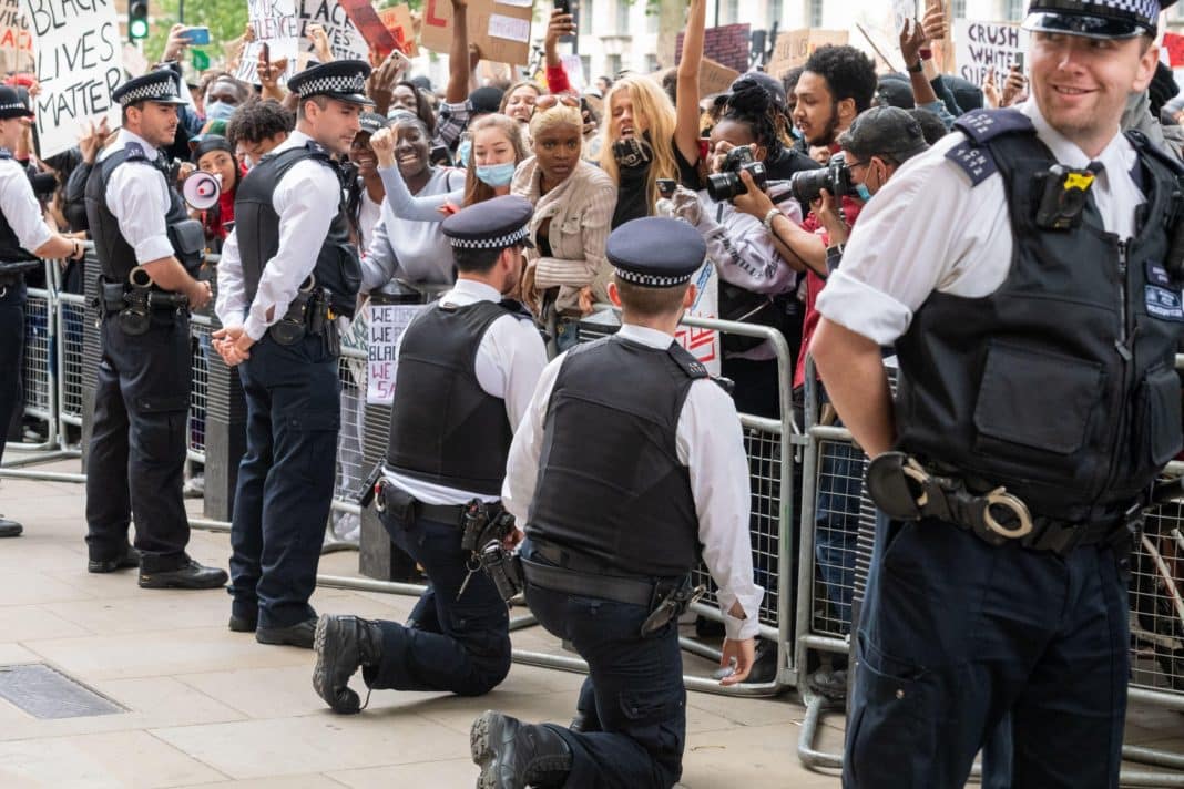 Police have been cautioned against 'taking the knee' at protests in a new report