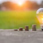 Light,Bulb,Energy,Saving,And,A,Coin,On,The,Floor
