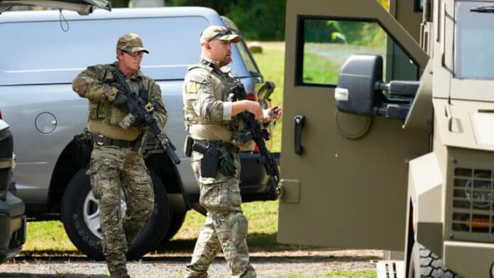 Law enforcement officers involved in the search for Cavalcante. Pic: AP © Associated Press